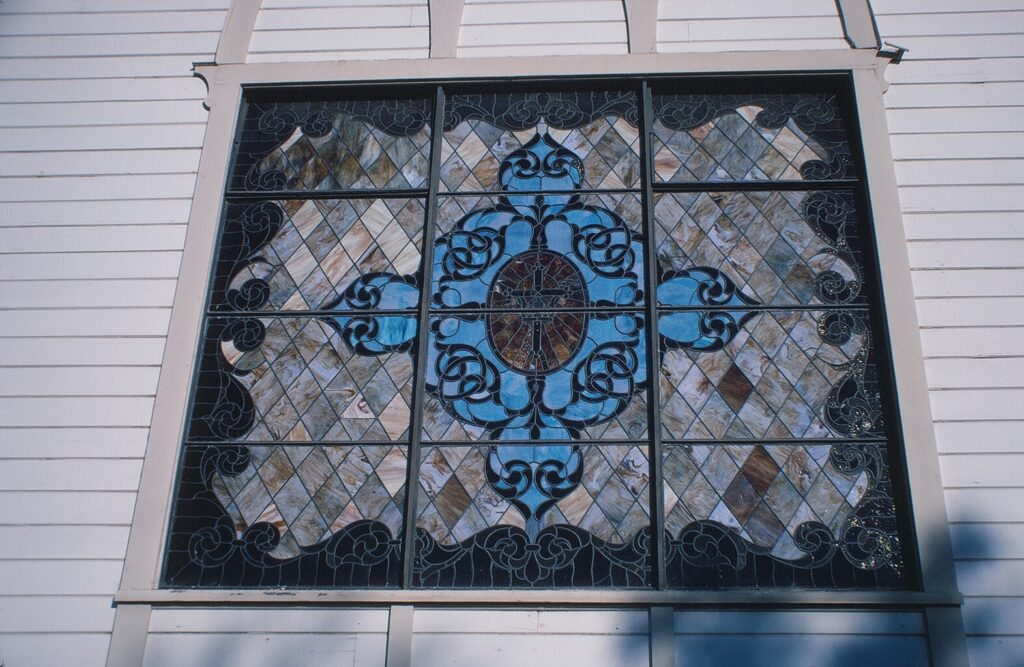 Detailed view of stained glass window at Bardsdale Methodist Church, showcasing intricate designs.
