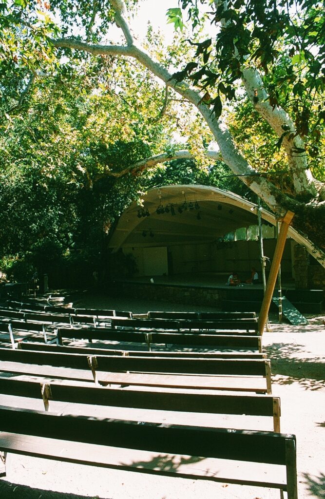Libbey Park Bowl with seating and stage, shaded by trees, circa 1980s.
