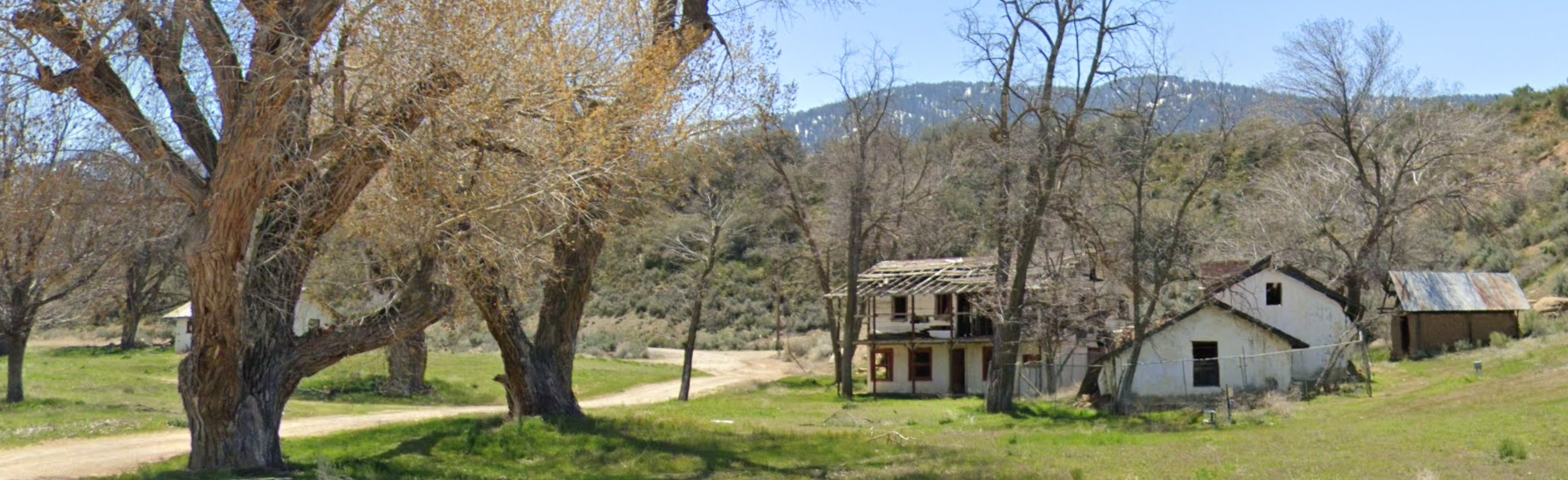 Ruins of the Rafael Reyes Adobe surrounded by trees, April 2023.