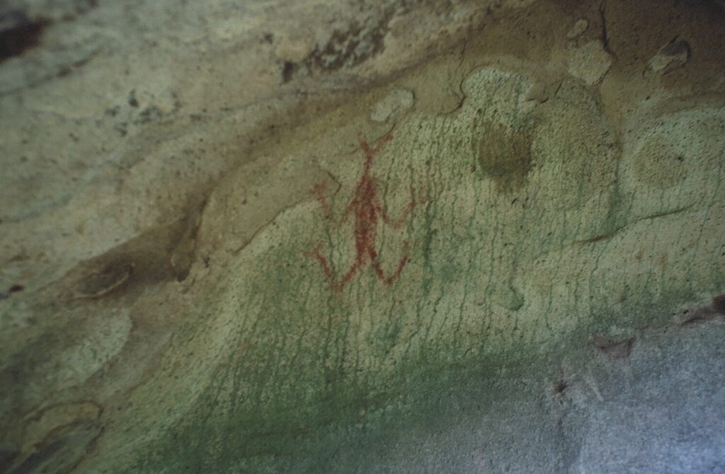 Chumash pictograph depicting a red figure on a cave wall.