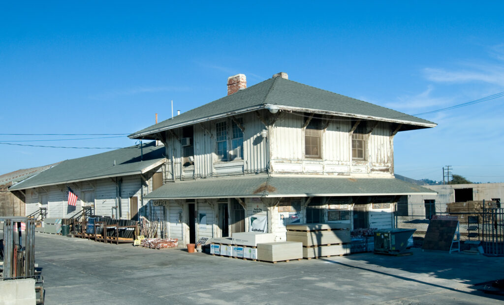 Saticoy’s Southern Pacific Railroad Depot in 2009, used as a building supply warehouse with materials and equipment visible.